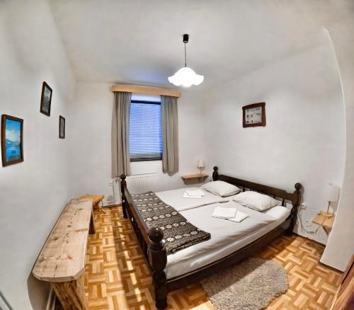 a bedroom with a bed and a wooden table at Alpine Home - Rooms in Kranjska Gora