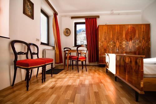 a bedroom with a bed and chairs and a table at Alpine Home - Rooms in Kranjska Gora