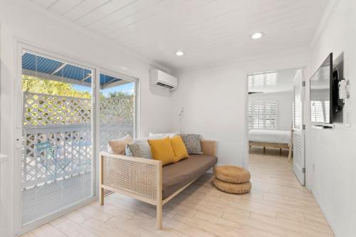 a living room with a couch and a balcony at Inn on the Beach in St Pete Beach