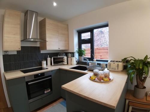 a kitchen with a plate of food on a counter at The Annexe Cheadle Hulme in Cheadle Hulme