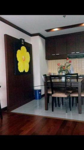 a dining room with a yellow flower on the door at Patong Tower Ocean View Apartment in Patong Beach