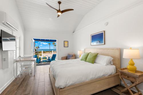 a bedroom with a bed and a view of the ocean at Inn on the Beach in St Pete Beach