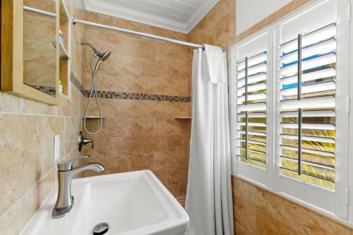 a bathroom with a sink and a shower at Inn on the Beach in St Pete Beach