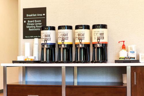 a group of wine bottles sitting on top of a shelf at Hampton Inn Lead in Lead