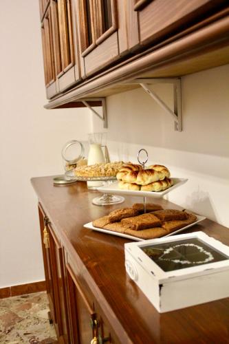 a kitchen counter with some pastries and bread on it at B&B DEGLI ANGELI in Lecce