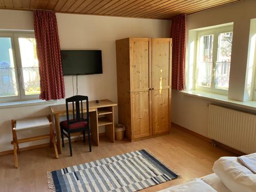 a bedroom with a desk and a chair and a table at Hotel & Landgasthof Zur Sonne 