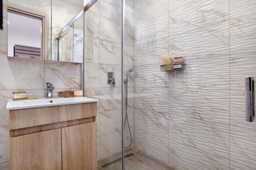 a bathroom with a sink and a shower at Athina's House in Dhrákas