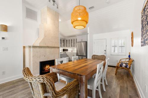 a dining room with a table and chairs and a fireplace at Inn on the Beach in St Pete Beach