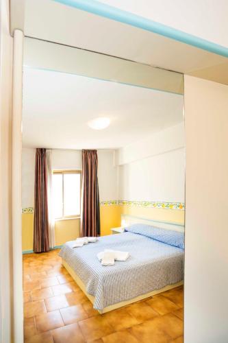a bedroom with a large bed in a room at Hotel San Pietro in Letojanni