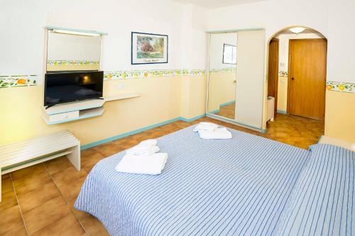 a room with a bed with towels on it at Hotel San Pietro in Letojanni