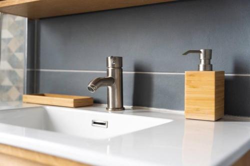 a bathroom sink with a faucet on a counter at Duplex Moderne Cosy - Proche Porte d'Italie - Parking in Le Kremlin-Bicêtre