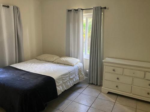a bedroom with a bed and a dresser and a window at 3 Bedroom Villa in Hollywood Beach in Hollywood
