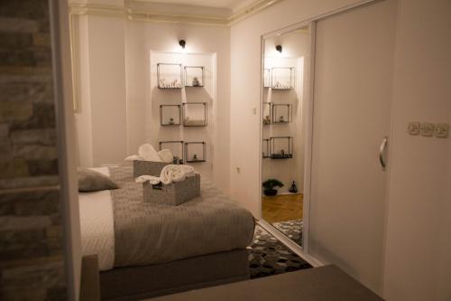a bedroom with a bed and a door leading to a hallway at Studio Apartman SubUrban in Višnjevac