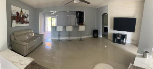 a living room with a couch and a tv at 3 Bedroom Villa in Hollywood Beach in Hollywood