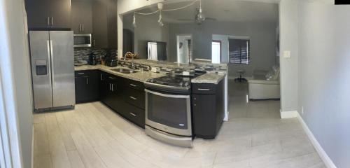 a large kitchen with a stove and a refrigerator at 3 Bedroom Villa in Hollywood Beach in Hollywood
