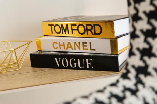 a stack of books sitting on a shelf at President Lux Apartment in Pale