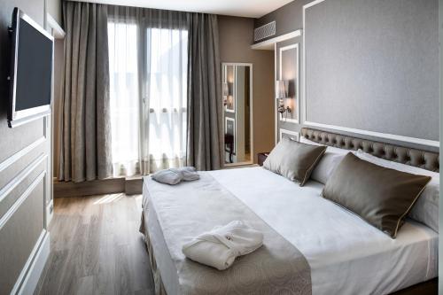 a bedroom with a large bed with towels on it at Catalonia Passeig de Gràcia 4* Sup in Barcelona