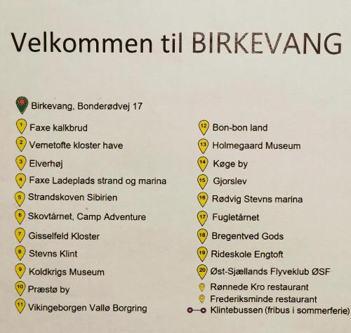 a menu for a vegan restaurant with yellow signs at Birkevang The Silo - Rural refuge in Faxe