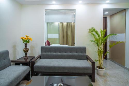 a living room with a couch and a table at The Lodgers 1 BHK Serviced Apartment Golf Course Road Gurgaon in Gurgaon