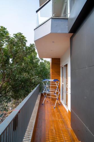 a balcony of a house with a bike on it at The Lodgers 1 BHK Serviced Apartment Golf Course Road Gurgaon in Gurgaon