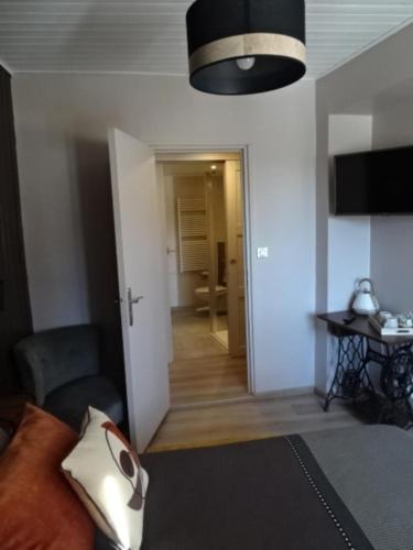 a living room with a couch and a room with a hallway at La Méridienne - Chambres d'hôtes in Venterol