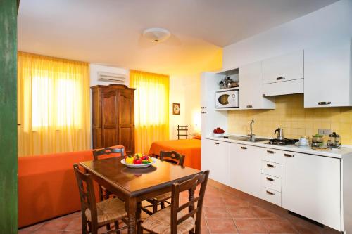 a kitchen and dining room with a table and chairs at Residence Degli Agrumi in Taormina