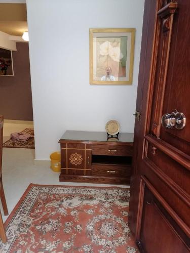 a room with a wooden door and a table at Cozy fully furnished studio in Cairo
