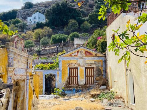 an old house on a hill in a village at Little Blue in Chorio, Symi in Symi