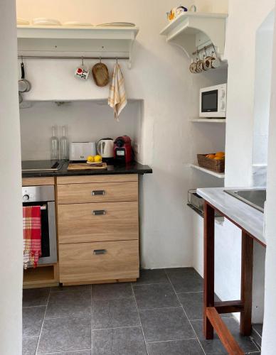 a kitchen with wooden cabinets and a counter top at Little Blue in Chorio, Symi in Symi