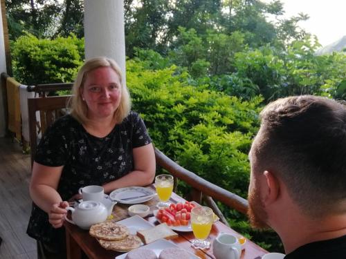 a man and a woman sitting at a table with food at Super View in Ella