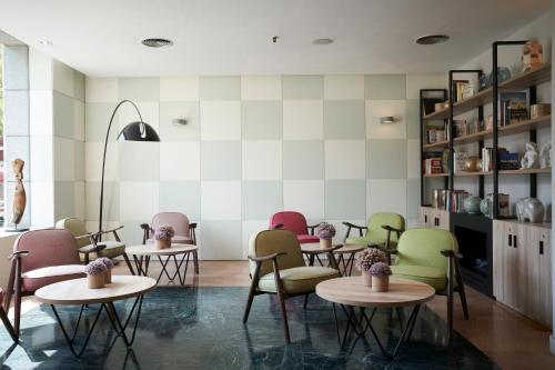 a restaurant with tables and chairs in a room at Catalonia Sabadell in Sabadell