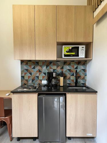 a kitchen with a refrigerator and a microwave at Mini Casa en Poblado Medellín FRN109 By Roots Rentals in Medellín