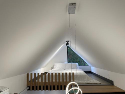 a bedroom with a bed in a loft at Mini Casa en Poblado Medellín FRN109 By Roots Rentals in Medellín