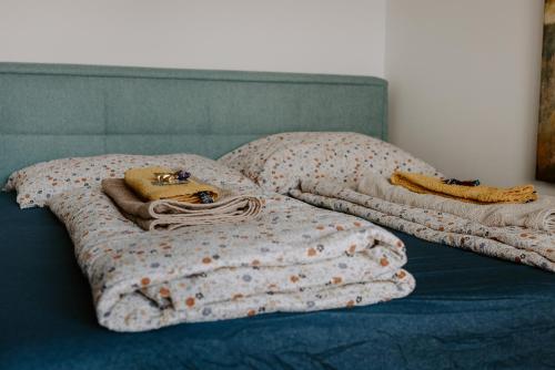 a bed with two pillows and a blanket on it at FAIRien from home in Neusiedl am See
