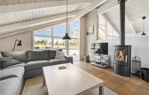 a living room with a couch and a fireplace at Gorgeous Home In Jerup With Kitchen in Jerup