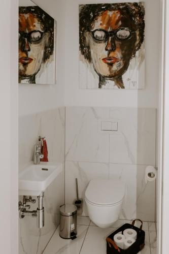 a bathroom with a toilet and a sink at FAIRien from home in Neusiedl am See