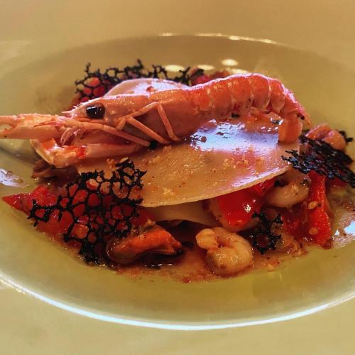 a plate of food with a lobster on top at B&B Royal in Sellia Marina
