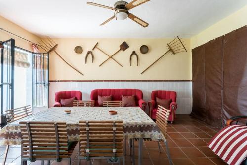 a dining room with a table and red chairs at La Francesa Doñana in Villamanrique de la Condesa
