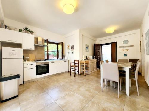 a kitchen and dining room with a table and chairs at Sperlonga By The Sea in Sperlonga