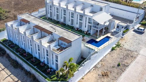 an aerial view of a white building at Beach Townhouses #C6 - Triplex por Carpediem in Mangabeira