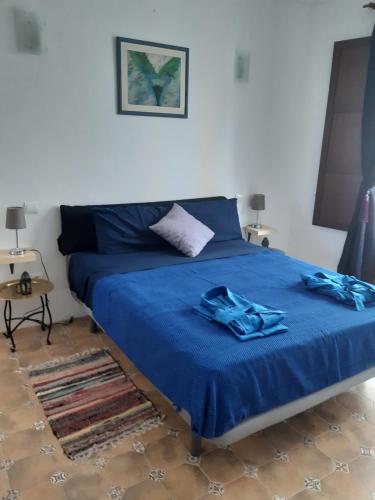 - une chambre avec un lit bleu et une couverture bleue dans l'établissement Ksar azul 6 pers à 2 mn de la plage, à La Vila Joiosa