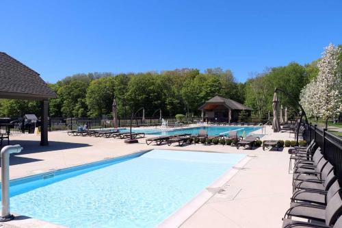 a large swimming pool with lounge chairs at Reflections in Harbor Springs