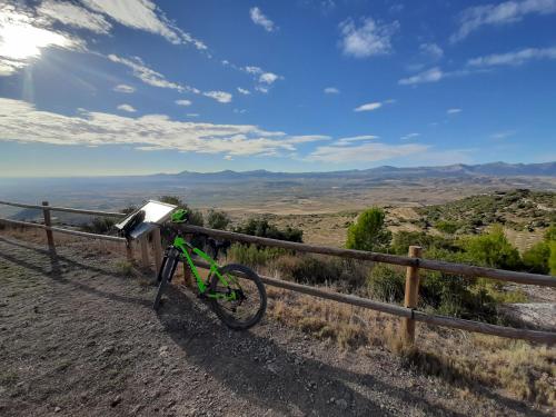 a bike parked next to a fence in the desert at Casa rural "Garnacha de Borja" guest home in Borja