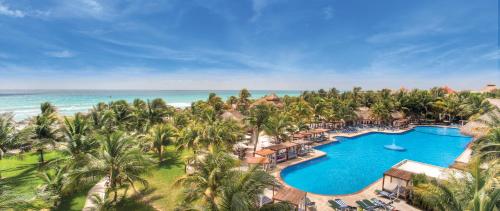 an aerial view of a resort with a swimming pool and the ocean at El Dorado Royale A Spa Resort - All Inclusive in Puerto Morelos