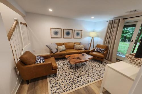 a living room with a couch and two chairs at Heart & Soul Hideaway in Harbor Springs