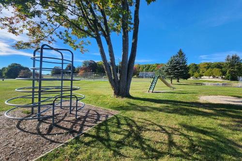 a park with a swing set in the grass at Heart & Soul Hideaway in Harbor Springs