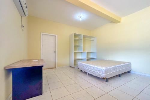 a bedroom with a bed and a cabinet in it at Casa com piscina em Itacimirim BA in Itacimirim