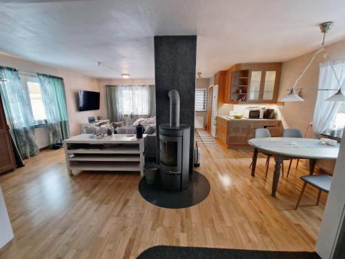 a living room with a woodburning stove in the middle at The High Coast House in Örnsköldsvik