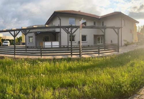 a large house with a fence in front of it at Apartamenty Zatorze in Leszno