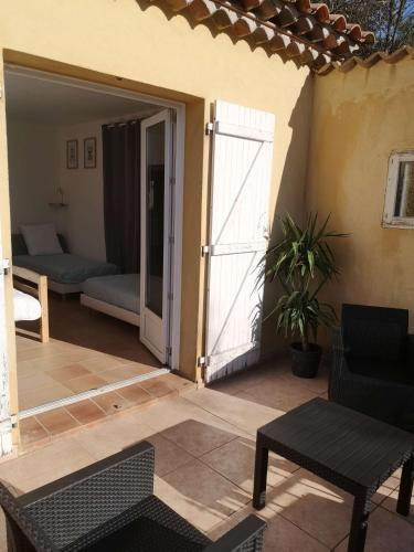 a patio with a door leading to a living room at Chez TATA in Régusse
